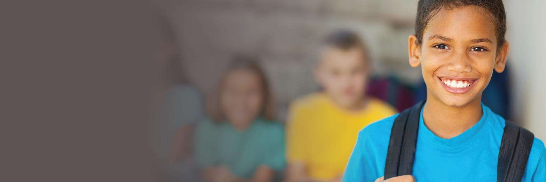 kid holding backpack strap