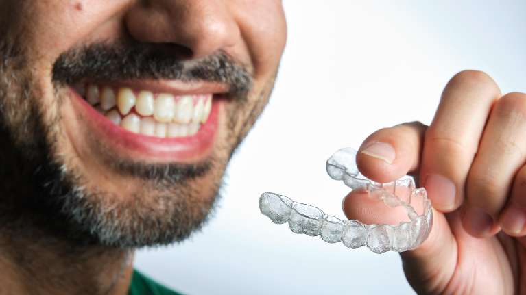man holding his Invisalign
