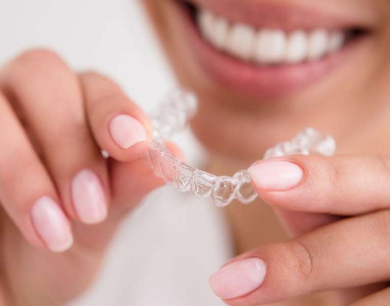 woman holding Invisalign
