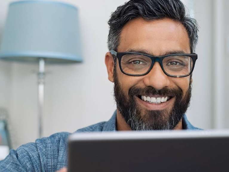 Man with glasses smiling